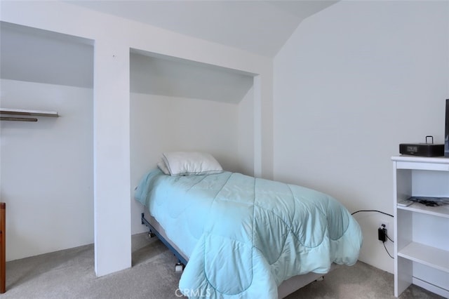 carpeted bedroom featuring vaulted ceiling