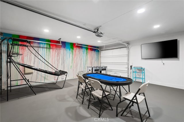 playroom featuring recessed lighting, finished concrete flooring, and a garage