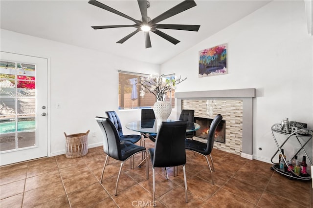 dining area featuring vaulted ceiling, a ceiling fan, tile patterned flooring, and plenty of natural light