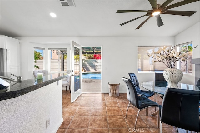 tiled dining area with recessed lighting, a ceiling fan, visible vents, and plenty of natural light