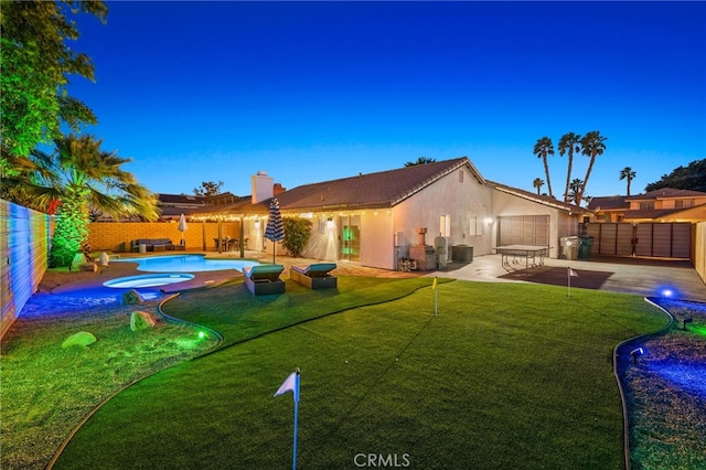 exterior space with a fenced backyard, a patio, a fenced in pool, and an in ground hot tub