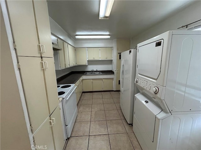 kitchen featuring a sink, stacked washer / dryer, white appliances, light tile patterned floors, and under cabinet range hood