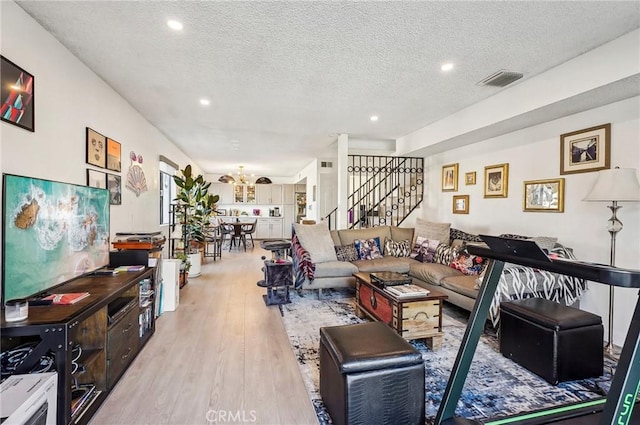 living area with a chandelier, stairway, visible vents, and recessed lighting
