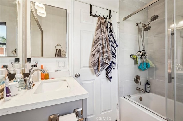 full bathroom featuring vanity and shower / bath combination with glass door