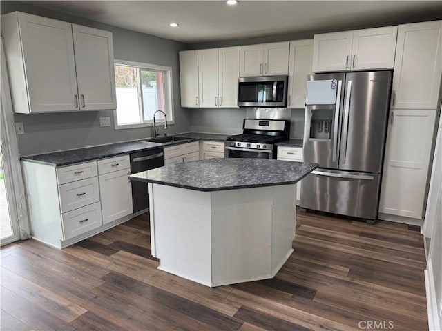 1176 Waxwing Dr, Vista, CA 92083 - kitchen with appliances with stainless steel finishes, a sink, recessed lighting, dark wood finished floors, and white cabinets