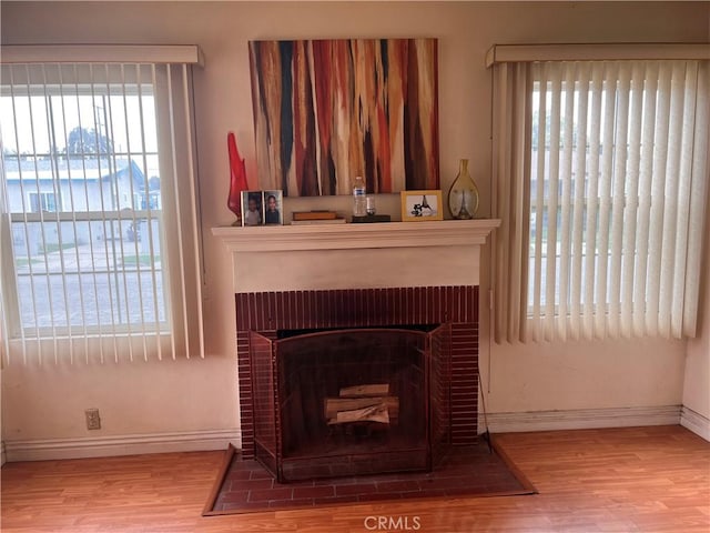 1423 S Poinsettia Ave, Compton, CA 90221 - detailed view of wood finished floors, baseboards, and a fireplace