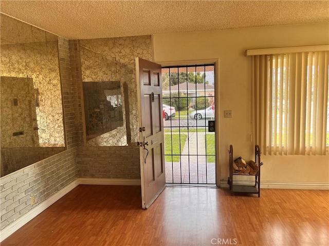 1423 S Poinsettia Ave, Compton, CA 90221 - doorway with wood finished floors, a textured ceiling, baseboards, and healthy amount of natural light