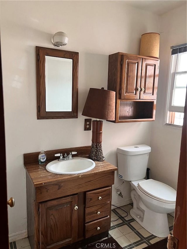 1423 S Poinsettia Ave, Compton, CA 90221 - half bathroom with toilet, vanity, and baseboards