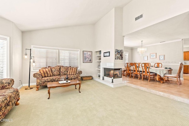2210 Via Loma, Camarillo, CA 93012 - carpeted living area with high vaulted ceiling, a chandelier, a fireplace, and built in shelves