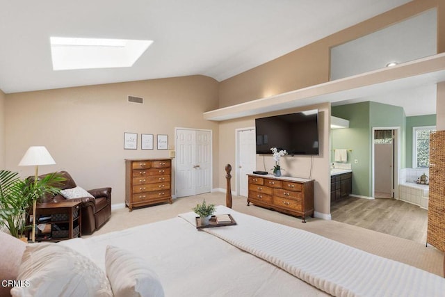 2210 Via Loma, Camarillo, CA 93012 - bedroom featuring a skylight, lofted ceiling, ensuite bathroom, light colored carpet, and a closet