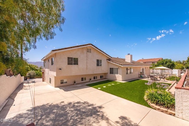 2210 Via Loma, Camarillo, CA 93012 - rear view of house with a patio area, a fenced backyard, stucco siding, and a chimney