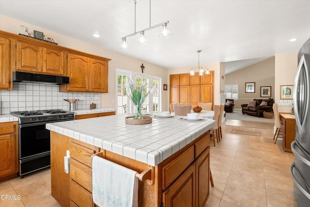2210 Via Loma, Camarillo, CA 93012 - kitchen with black gas stove, extractor fan, tile counters, a kitchen island, and freestanding refrigerator