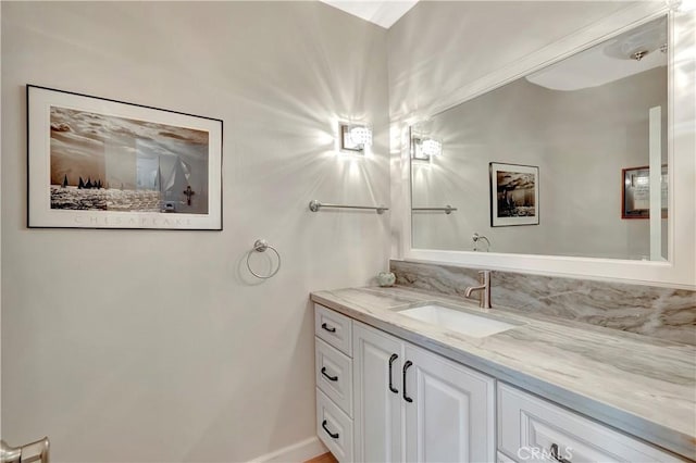 bathroom featuring baseboards and vanity