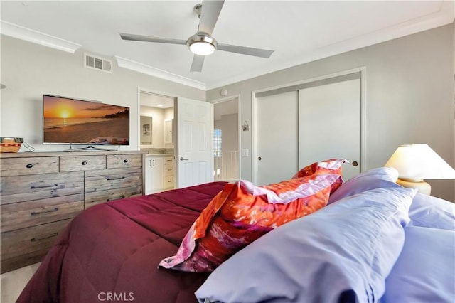 bedroom featuring visible vents, a ceiling fan, a closet, crown molding, and ensuite bathroom
