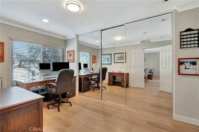 office space featuring recessed lighting, ornamental molding, light wood-type flooring, and plenty of natural light