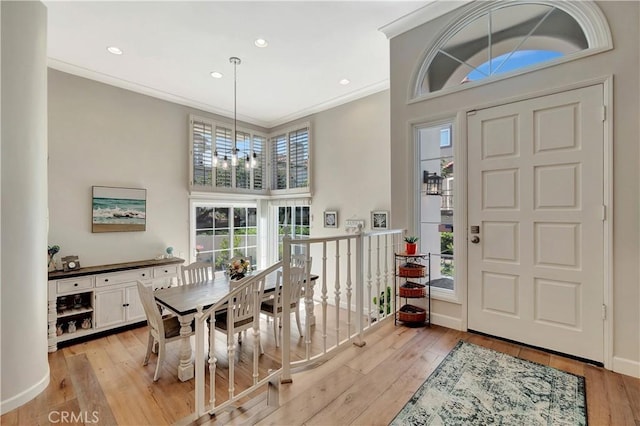 foyer entrance featuring recessed lighting, crown molding, and light wood-type flooring