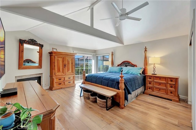 bedroom featuring access to exterior, vaulted ceiling with beams, light wood-style floors, a premium fireplace, and ceiling fan