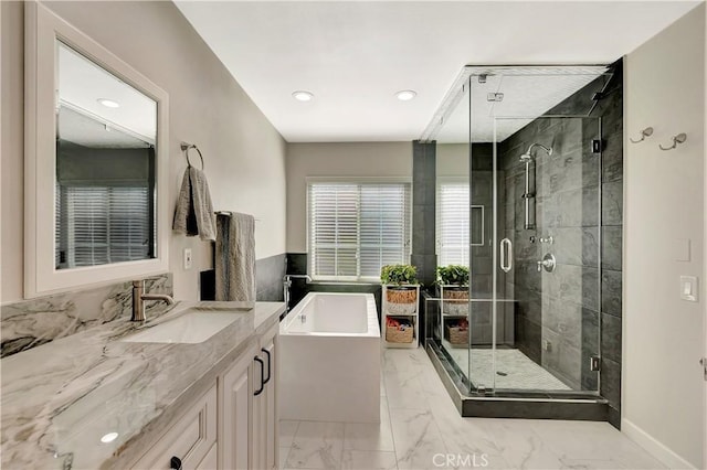 full bathroom featuring a bathtub, recessed lighting, marble finish floor, a shower stall, and vanity