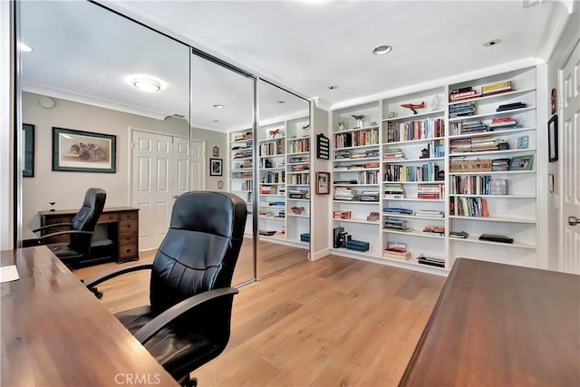 office area featuring light wood finished floors and ornamental molding