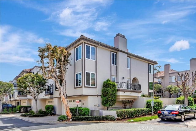 view of building exterior with a residential view and a garage