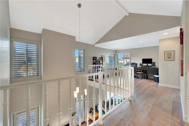 corridor featuring high vaulted ceiling, wood finished floors, an upstairs landing, baseboards, and beam ceiling
