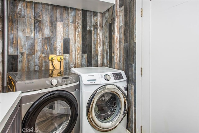clothes washing area featuring washer and dryer