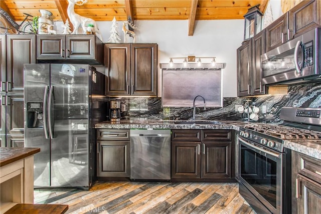 kitchen featuring wooden ceiling, appliances with stainless steel finishes, beam ceiling, and light wood-style floors