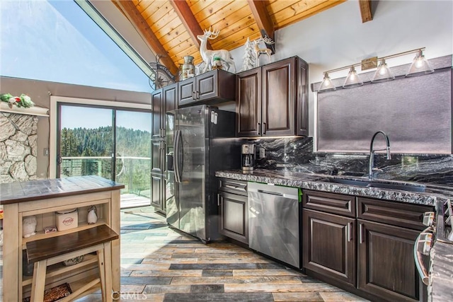 kitchen featuring a sink, lofted ceiling with beams, wood ceiling, stainless steel appliances, and wood-type flooring