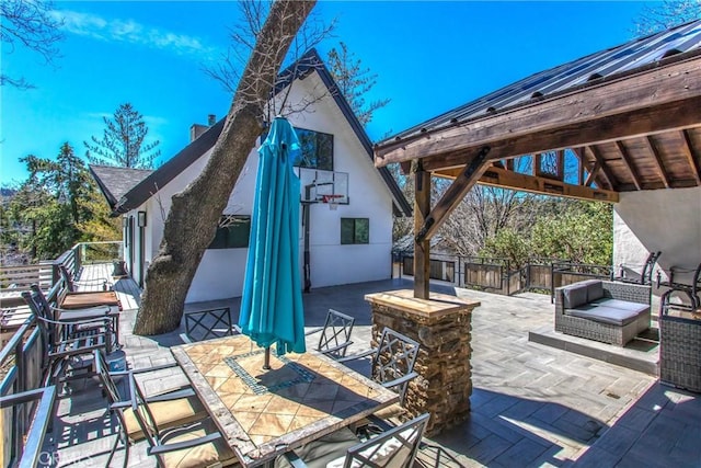 view of patio with fence and outdoor dining area