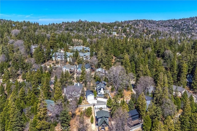 birds eye view of property featuring a residential view and a wooded view