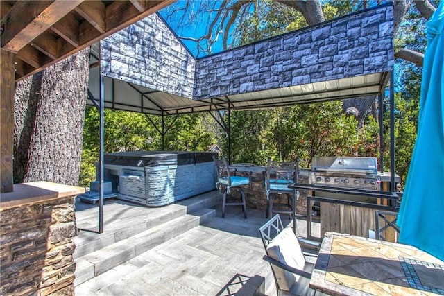 view of patio / terrace with a gazebo, a hot tub, and area for grilling