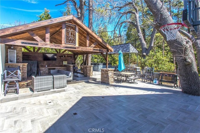 view of patio / terrace featuring an outdoor living space, a gazebo, and exterior kitchen