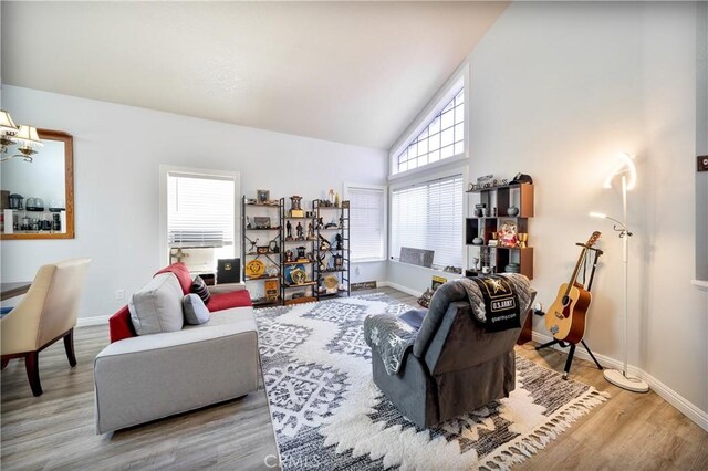 39240 Gunsmoke Ct, Palmdale, CA 93551 - living room with baseboards, high vaulted ceiling, and wood finished floors