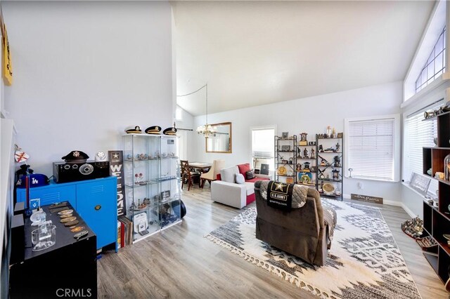 39240 Gunsmoke Ct, Palmdale, CA 93551 - living room featuring lofted ceiling, an inviting chandelier, and wood finished floors