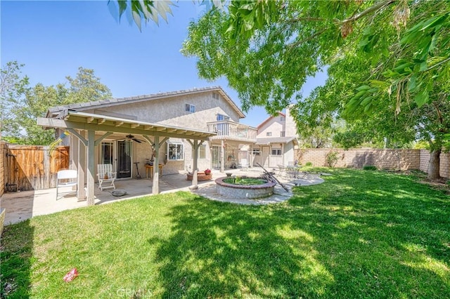 39240 Gunsmoke Ct, Palmdale, CA 93551 - rear view of house with a fenced backyard, stucco siding, a yard, a patio, and a ceiling fan