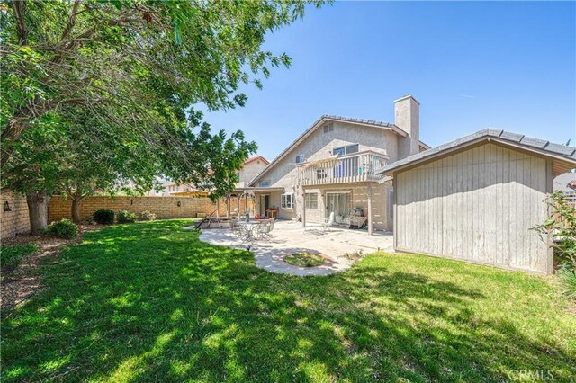 39240 Gunsmoke Ct, Palmdale, CA 93551 - rear view of property with a chimney, a fenced backyard, a patio, a balcony, and a lawn