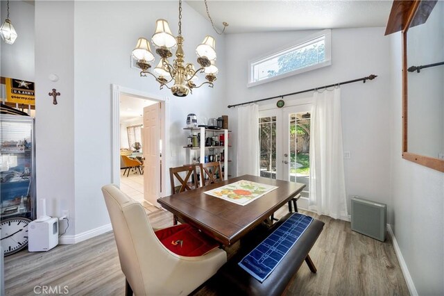 39240 Gunsmoke Ct, Palmdale, CA 93551 - dining area with light wood-style floors, baseboards, an inviting chandelier, french doors, and high vaulted ceiling