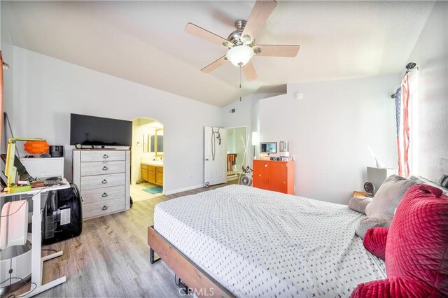 39240 Gunsmoke Ct, Palmdale, CA 93551 - bedroom with ceiling fan, light wood-type flooring, arched walkways, lofted ceiling, and ensuite bathroom