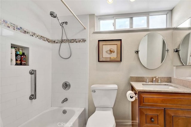 bathroom with toilet, vanity, and shower / tub combination