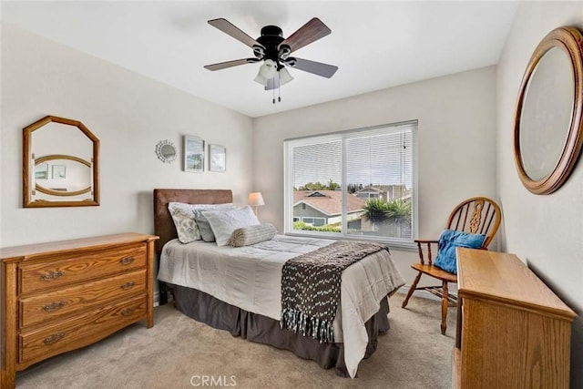 bedroom with light colored carpet and ceiling fan