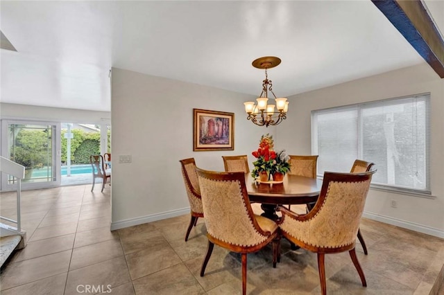 dining space with baseboards, a chandelier, and light tile patterned floors