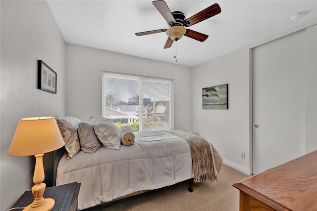 bedroom with carpet flooring, baseboards, and a ceiling fan