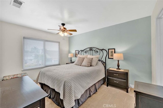 bedroom featuring light colored carpet, ceiling fan, and baseboards