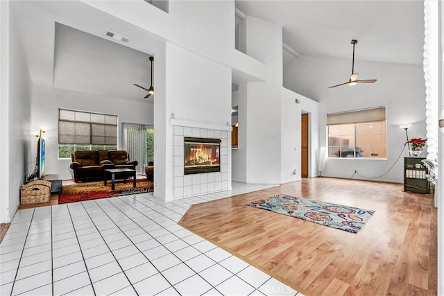 6845 Shubin Ln, Whittier, CA 90606 - tiled living area with baseboards, visible vents, high vaulted ceiling, ceiling fan, and a fireplace