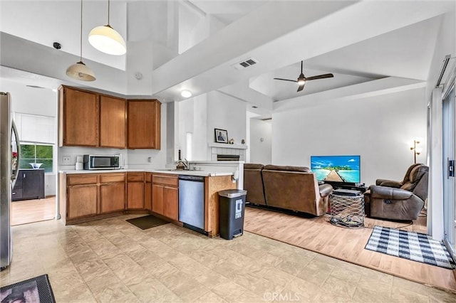 6845 Shubin Ln, Whittier, CA 90606 - kitchen with open floor plan, light countertops, brown cabinets, and appliances with stainless steel finishes