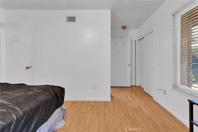 1844 Alston Ave, Colton, CA 92324 - bedroom featuring light wood-type flooring and multiple windows