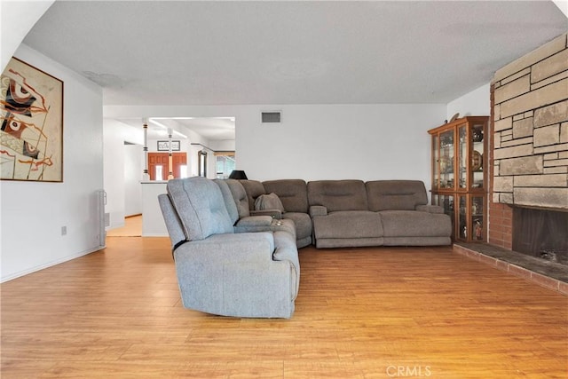 1844 Alston Ave, Colton, CA 92324 - living area with light wood-style flooring and a fireplace