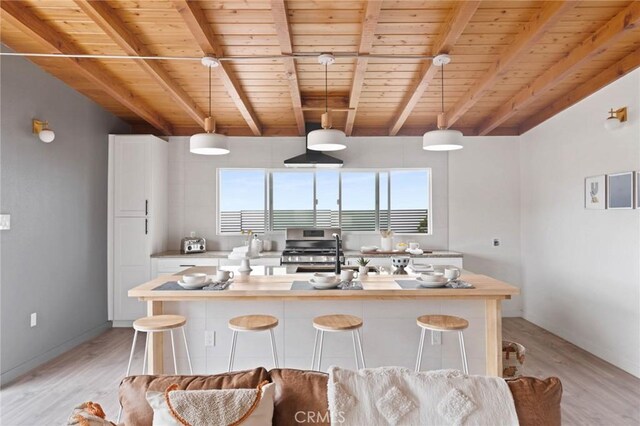 52024 Nehlsen Rd, Johnson Valley, CA 92285 - kitchen featuring light wood finished floors, stainless steel range with gas cooktop, wood ceiling, light countertops, and hanging light fixtures