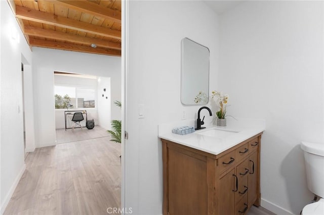 52024 Nehlsen Rd, Johnson Valley, CA 92285 - bathroom featuring beamed ceiling, wood finished floors, toilet, and wooden ceiling