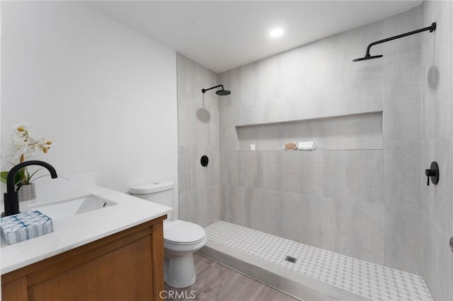 52024 Nehlsen Rd, Johnson Valley, CA 92285 - full bathroom featuring tiled shower, wood finished floors, vanity, and toilet